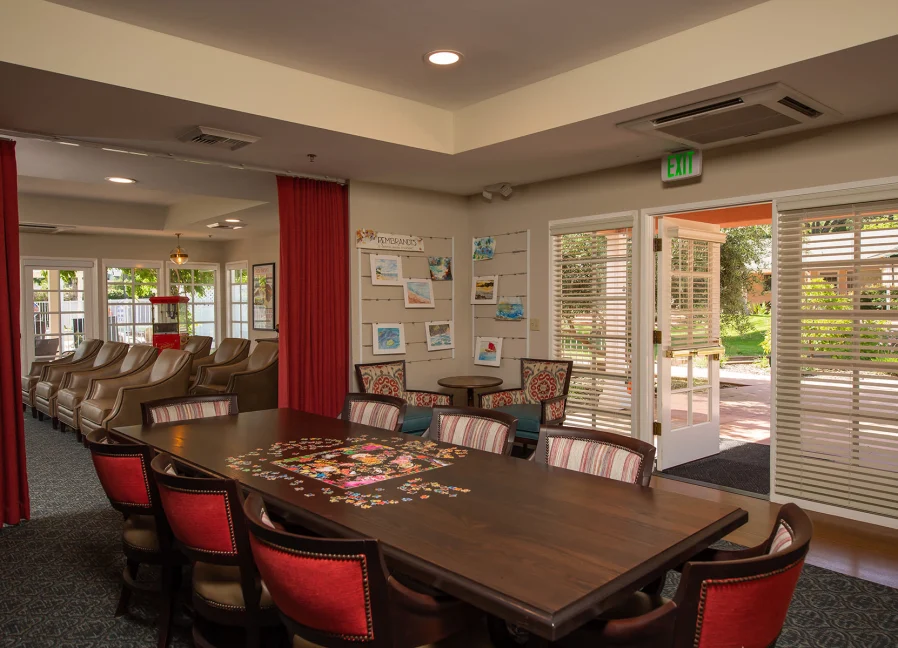 Spacious activity room with puzzle table and seating