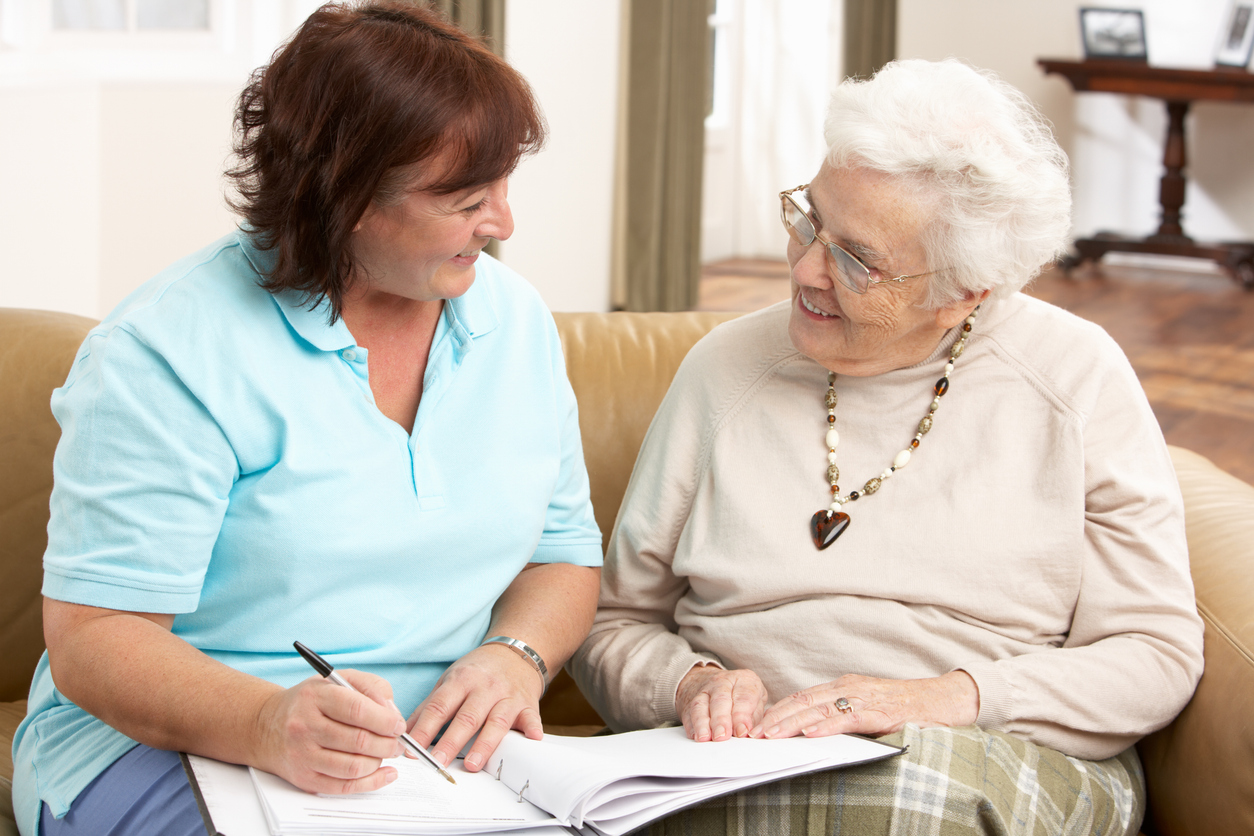 Caregiver consulting with independent living resident at Gables of Ojai